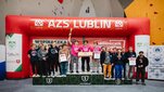 Image of students standing on a podium of a climbing championship in Lublin