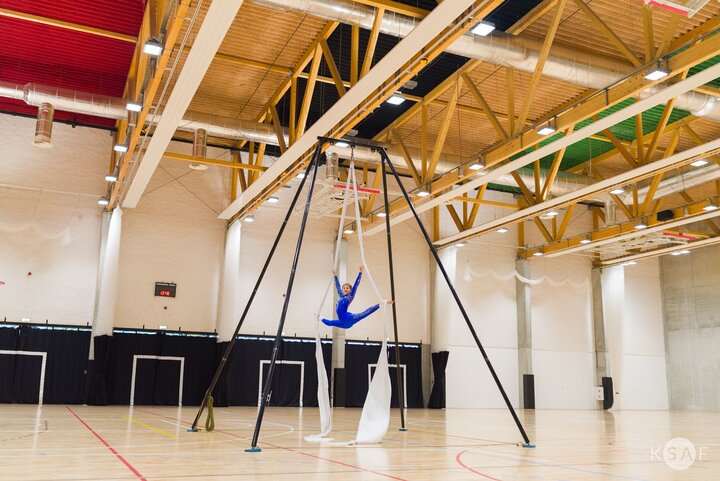 Interior of the new sports hall. Show by a female gymnast on silks