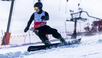 Image of a snowboarder in motion during a competiton