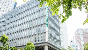 The photo shows a modern building of the Shibaura Institute of Technology Campus.