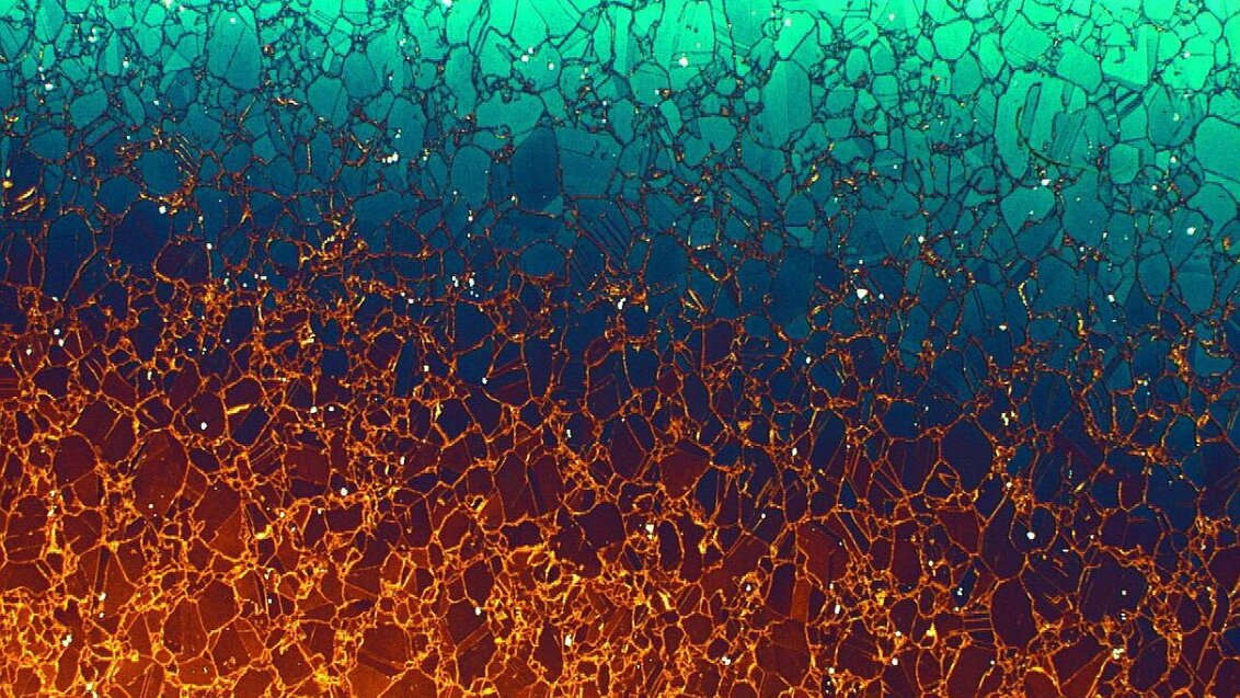 Abstract porous lattice structure in blue, turquoise, orange, and gold tones.