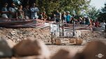 A Martian rover during the European Rover Challenge on the AGH University campus. The robot is moving along a Marsyard watched by spectators.