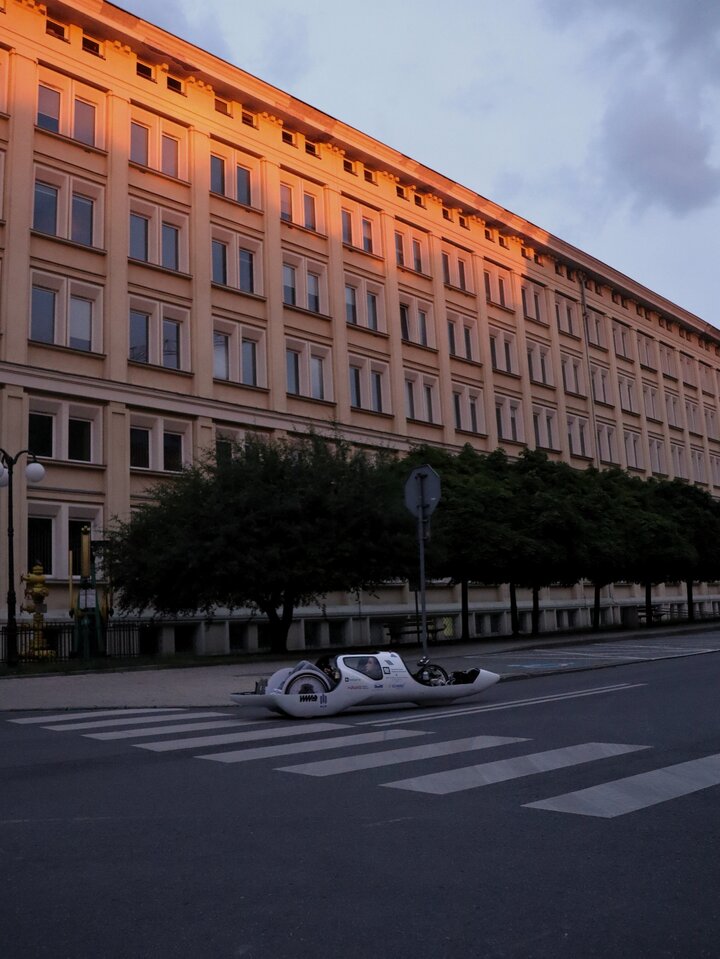 The photo presents Hydrive driving somewhere on the university campus at sunset.