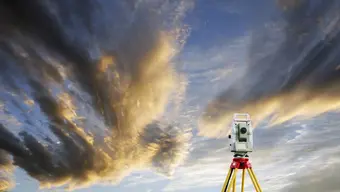 Image of the sky with a surveying instrument visible in the bottom right corner