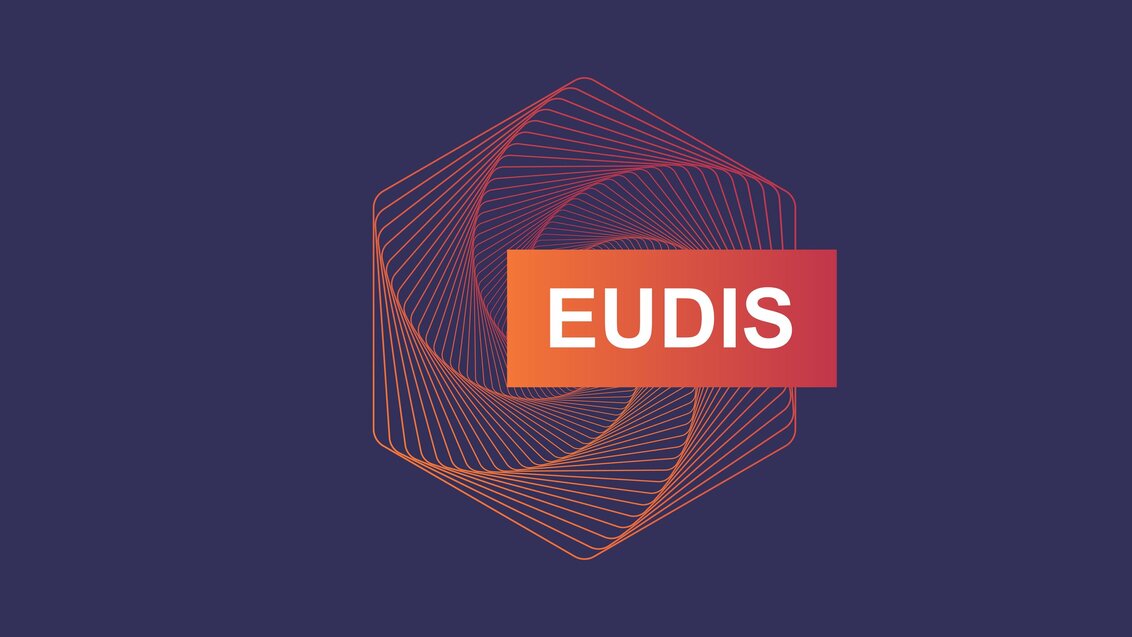The logotype of EUDIS, an orange geometrical shape over a purple background.