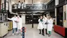 Image of groups of students in lab coats working in a specialistic laboratory
