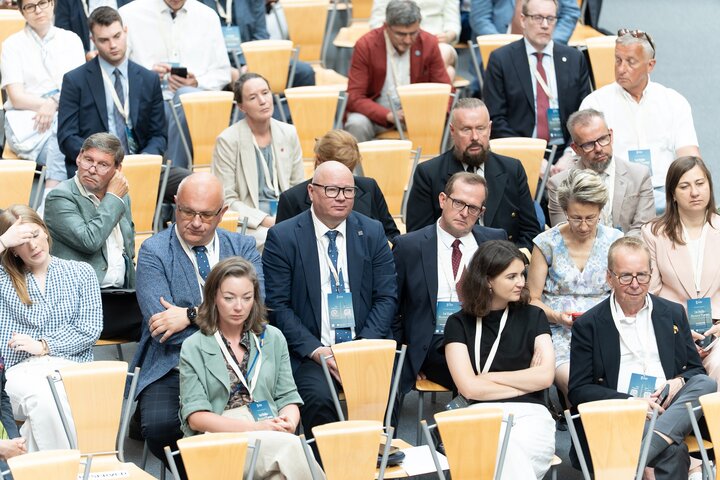 Audience members seated in rows during a conference session.