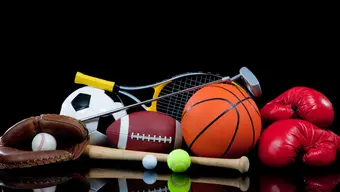 Various objects related to sports: a basketball, a tennis ball and rocket on a black background.