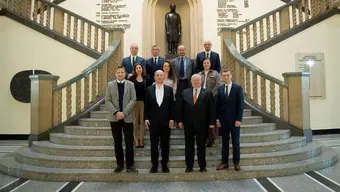 Zdjęcie grupowe przedstawicieli AGH oraz firmy Comarch wykonane w holu budynku głównego. Na schodach w trzech rzędach stoi obok siebie 11 osób (mężczyźni i kobiety).