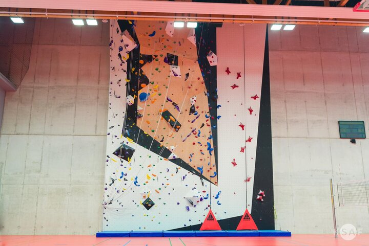 interior of the new sports hall, a climbing wall in the middle. 