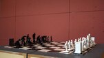 image of a chess set on a red background