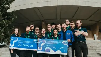 Image of the AGH Space Systems team in front of a building with the award in the Direction:Space competition