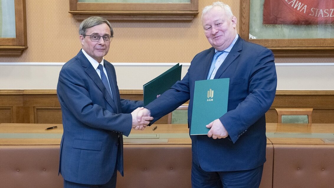 Image of two elegant men shaking hands and holding folders