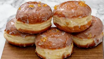 An image of five yeast pastries called pączki