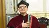 Professor Janusz Kowal minutes after being awarded the title with the epitogium pinned on a ceremonial burgundy toga.