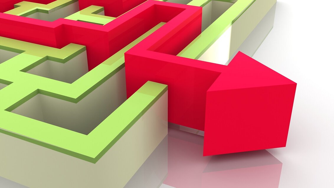 A decorative image of a red arrow escaping a green maze..
