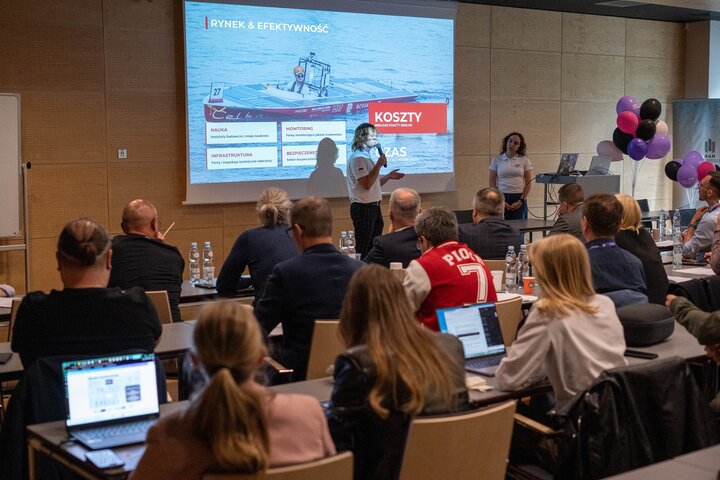Two students holding a presentation before an audience.