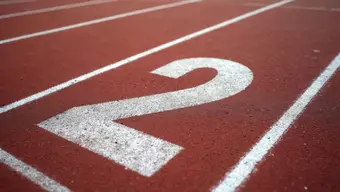 An image of number 2 on a running track.