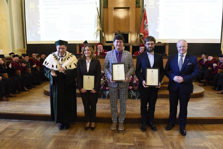 Five people in a commemorative photograph.