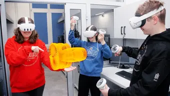 Image of three students in VR googles working on a 3D project