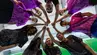 A group of young athletes standing in a circle, holding out their hands to the centre. 