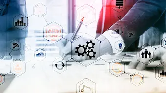 A decorative image of two professionals working in a business setting, overlaid with interconnected hexagonal icons representing technology concepts like innovation, analytics, automation, and connectivity.