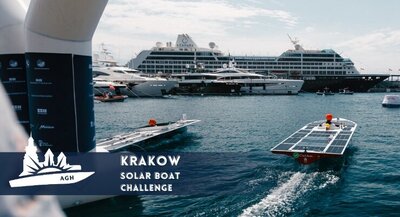 A promotional image of the Krakow Solar Boat Challenge with a logo of the event to the left. The image shows solar boats sailing in a bay with cruise ships and yachts in the background.