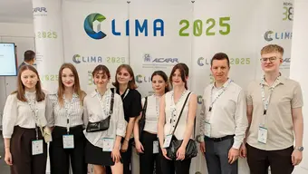 The photo presents a group of students standing in front of the CLIMA 2025 backdrop.