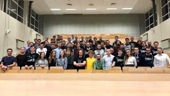 Image of Integra Club members in a large room