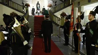 Image of the traditional ceremony accompanying St Barbara's Day in the main building of the AGH University; student representatives visible holding the university banner