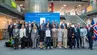 Group photo at the 1st Baltic Rectors’ Forum during the signing ceremony of the Gdańsk Declaration, with attendees standing in front of a blue event backdrop in a modern indoor atrium.