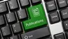 A fragment of a computer keyboard. One of the keys is green and has ‘publications’ written on it.