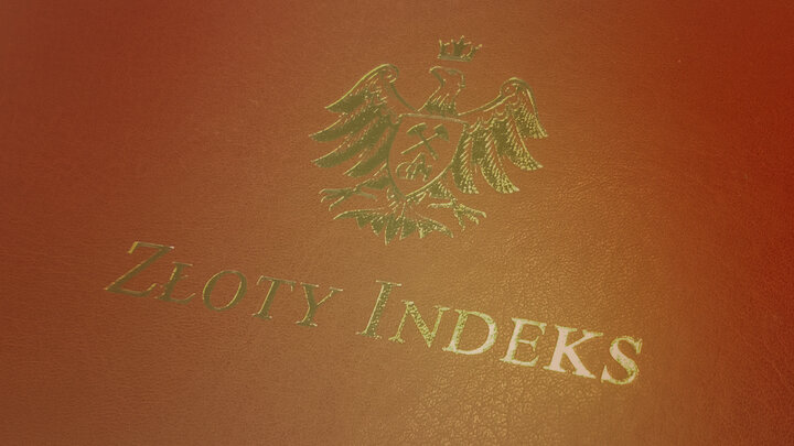 Zdjęcie przedstawiające zbliżenie na twardą okładkę z literami "ZŁOTY INDEKS" oraz godłęm w podstaci orła.