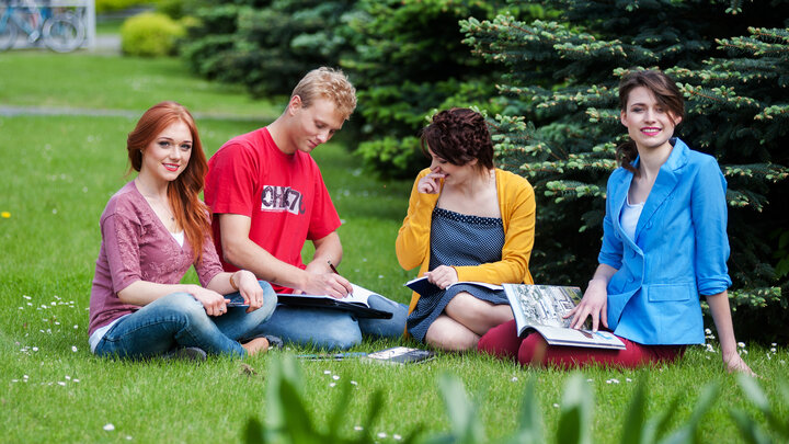 Students sitting on a grass