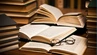 A decorative image with stacks of books on a table.