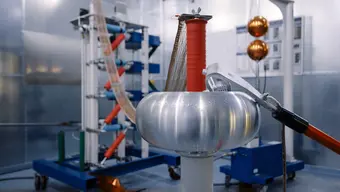 Jasne wnętrze laboratorium. Fragment metalicznej aparatury przeznaczonej do badań dużych prądów..