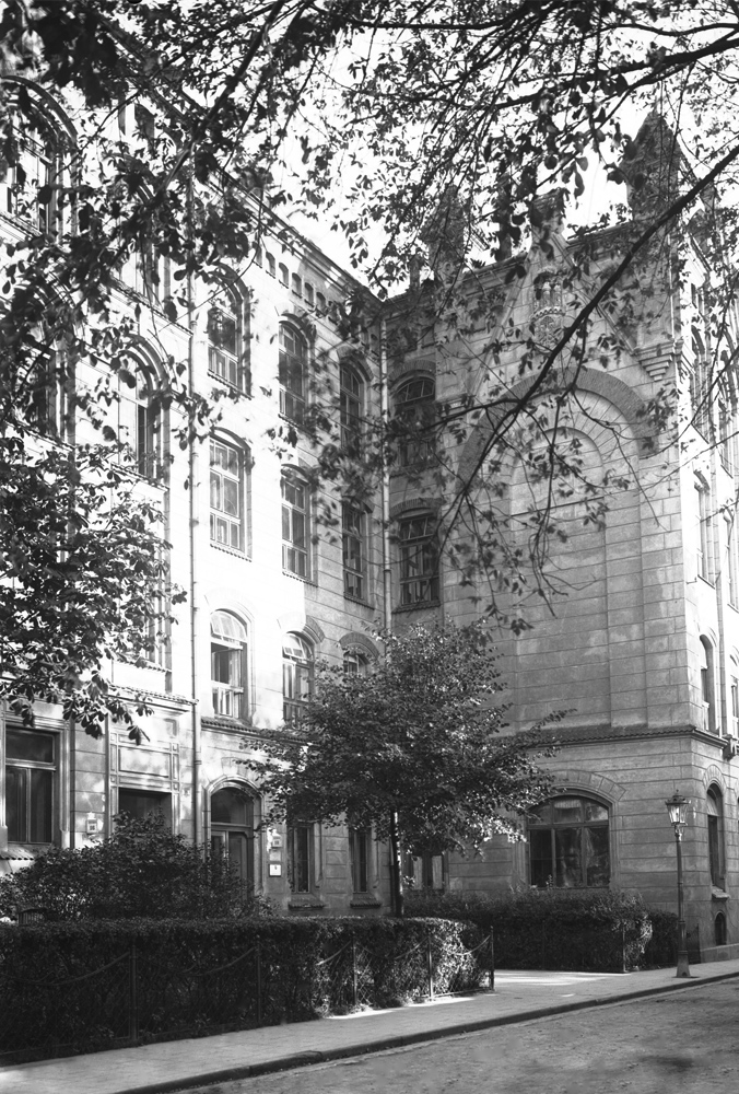 A black-and-white photo of a facade of a historical building.