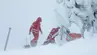 Image of a rescue team working on a sowy mountain